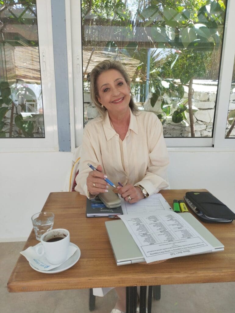 “Writing retreat attendees working on their manuscripts outdoors in Greece