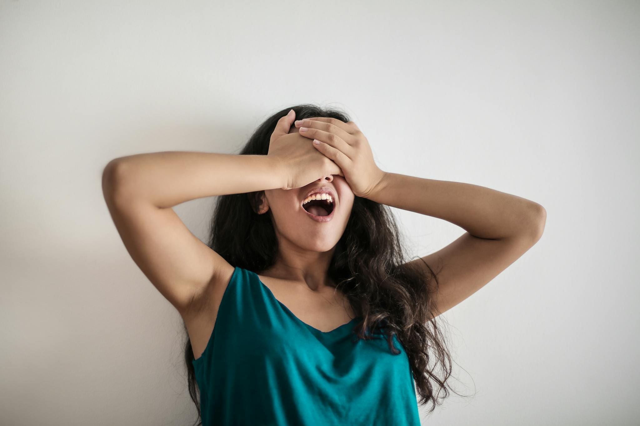 Literary & Wellness Retreats — Imagine Greece Retreats | Imagine Greece Retreats Young long haired female standing with opened mouth and covering eyes with hands in surprise against white background